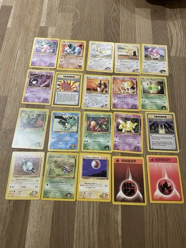 Around twenty Gym-era cards laid out on a wooden floor.