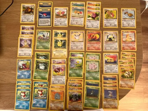 Around forty-five Base and Jungle era cards laid out in rows on a table.