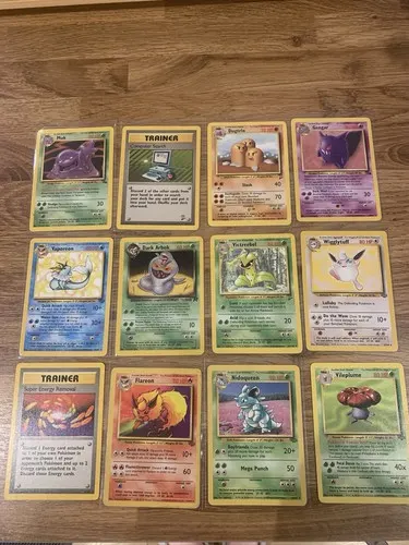 Twelve Fossil and Team Rocket era cards laid out in three rows.