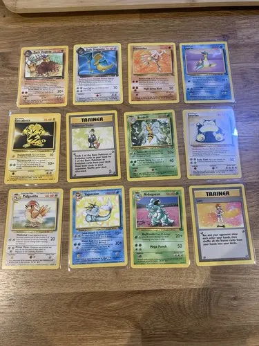 Twelve Team Rocket era holographic cards laid out in three rows, including Dark Dragonite.