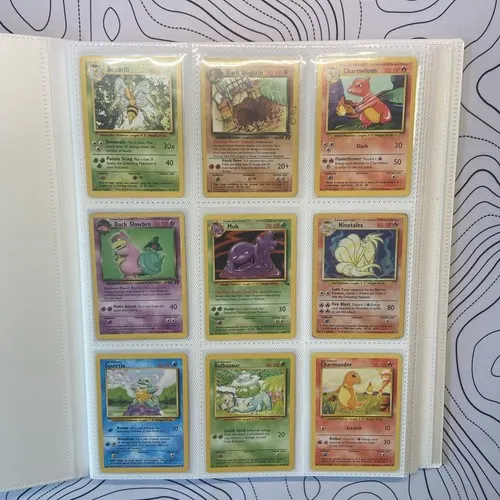 A binder page holding nine Team Rocket era holographic cards in sleeves.