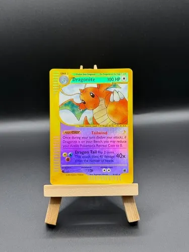 A single reverse-holographic Dragonite card on a small wooden display stand.
