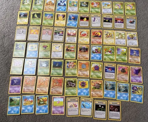 Around eighty cards including trainers, laid out in rows on a table.