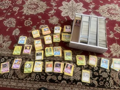 A four-row storage box packed with cards, alongside around twenty-five sorted stacks.